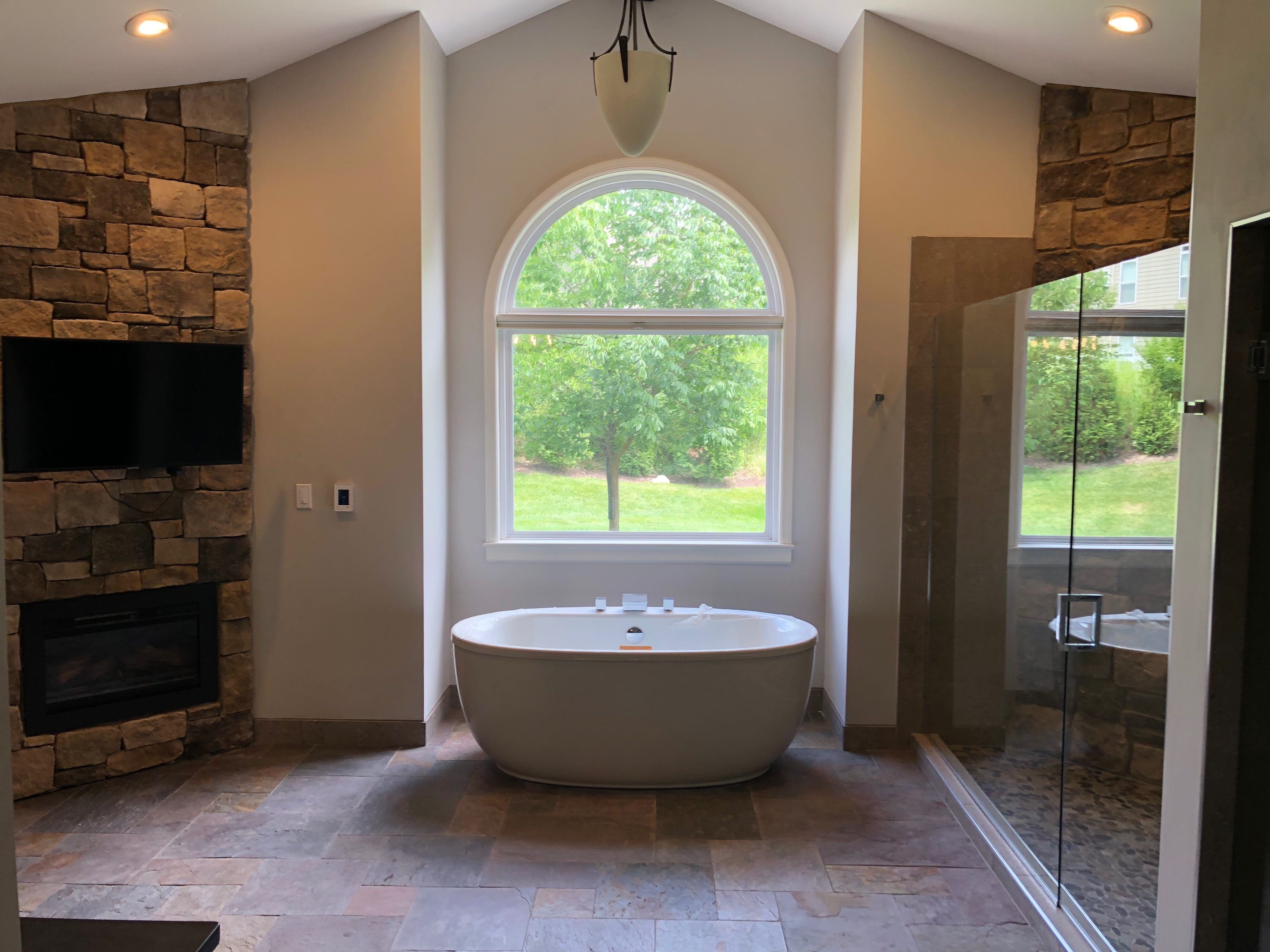 A large master bathroom with freestanding tub done by a skilled bathroom remodeling contractor.