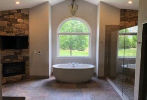 A grandiose master bathroom featuring a freestanding tub and large shower stall done by a skilled bathroom remodeling contractor.