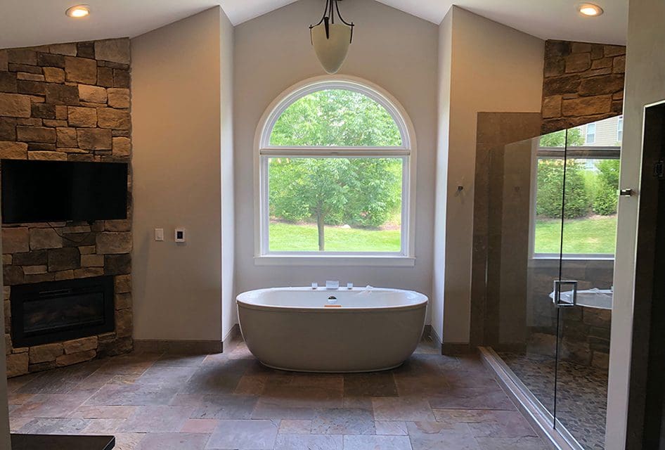 A grandiose master bathroom featuring a freestanding tub and large shower stall done by a skilled bathroom remodeler in St. Louis, MO.