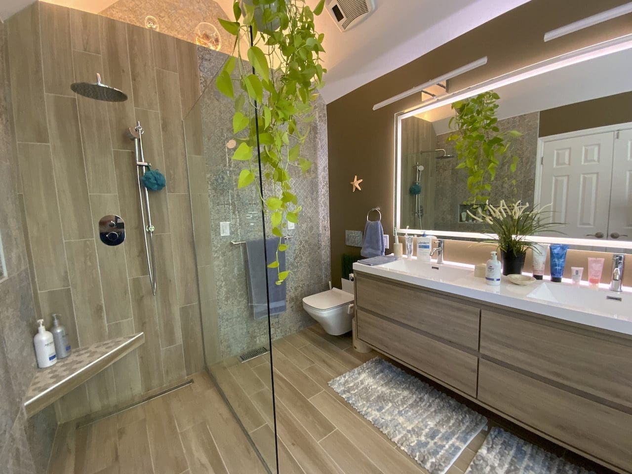 Modern european master bathroom remodel designed with a wall-hung toilet and a floating vanity.
