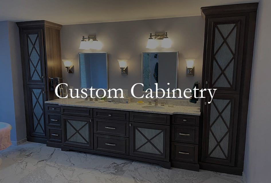 A large master bathroom vanity with glass inserts in the cabinet doors completes this homeowner's home remodeling project.