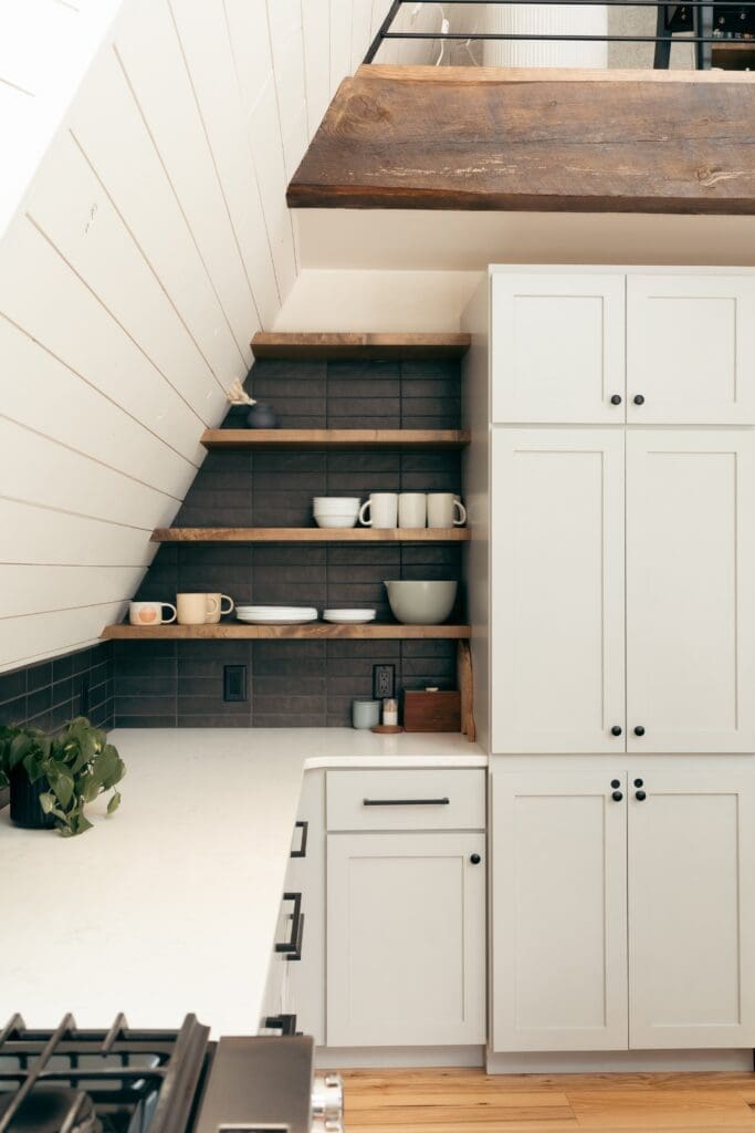 Wooden open shelving in a small kitchen in St. Louis.