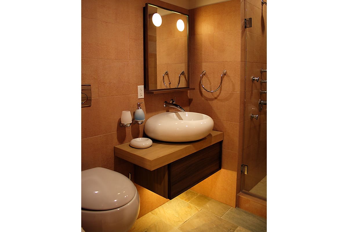 A luxury bathroom remodel in orange and brown colors.